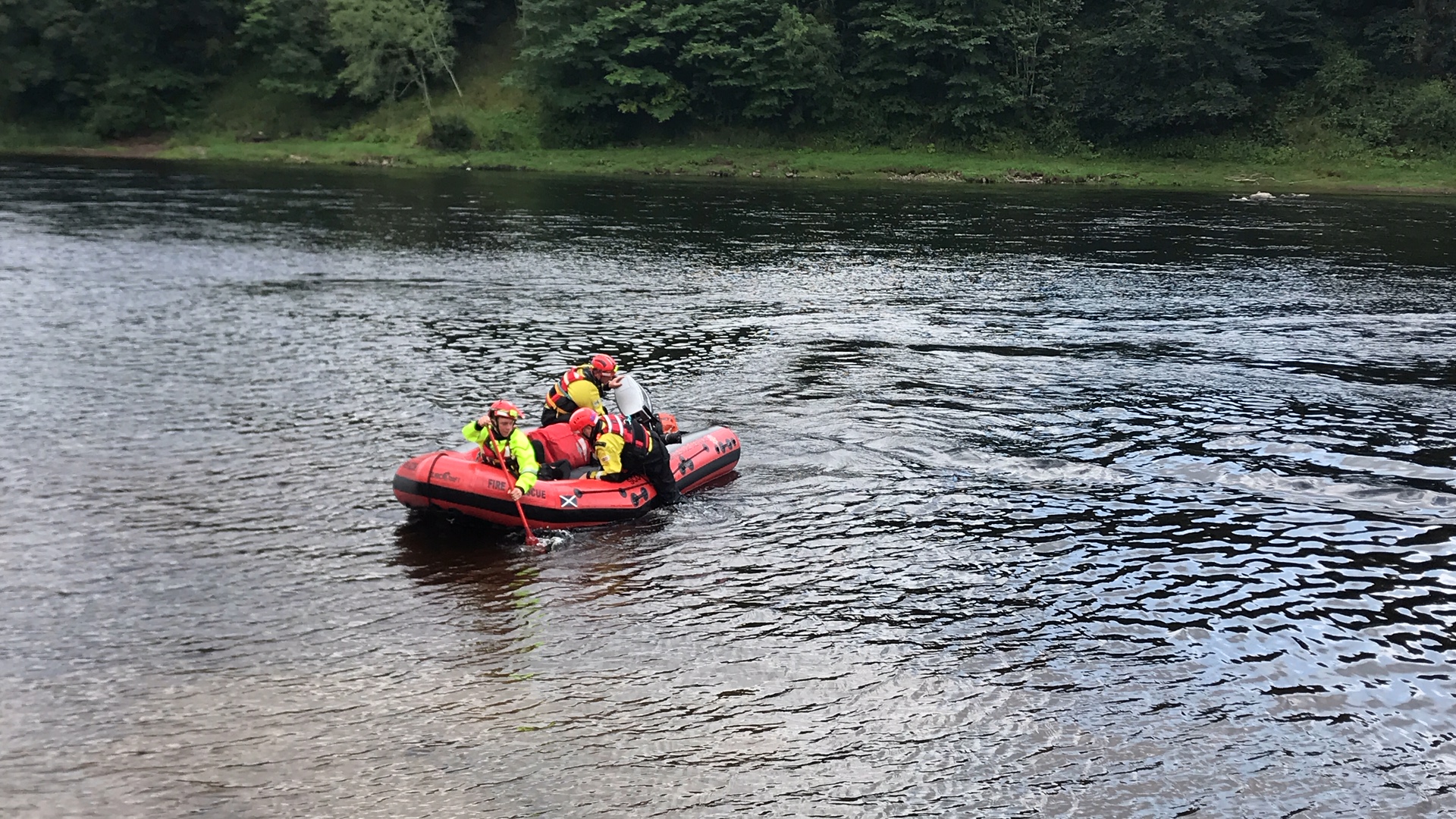 A water rescue team for the Scottish Fire and Rescue Service paddles on the River Tay near Stanley.