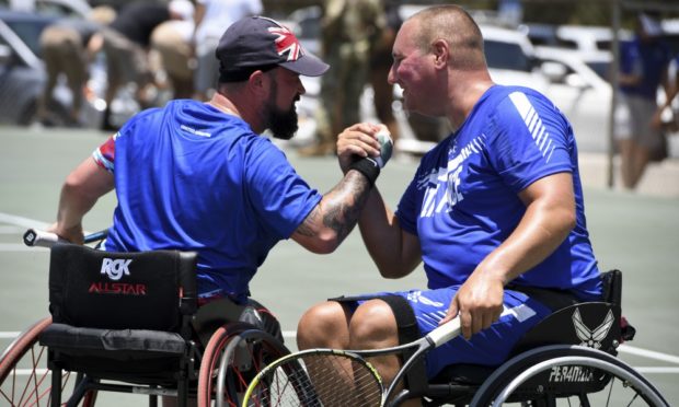 John (left) won gold with American Staff Sgt. Brian Biviano.