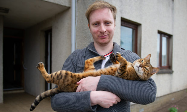 Paul Forrest and his pet cat Riley.