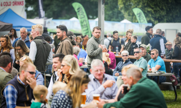 Crowds enjoying refreshments at the Scottish Game Fair at Scone Palace.