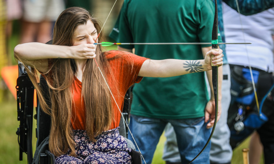 Hollie Morrison trying her hand at archery at the Scottish Game Fair.
