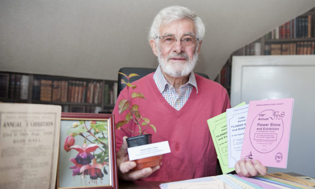 Forfar Horticultural Society chairman Jim Ewing with previous show memorabilia.