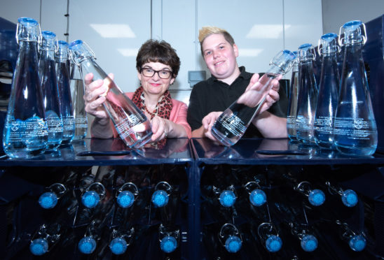 Professor Sally Mapstone and Gemma McNicoll-Brown with the new bottles.