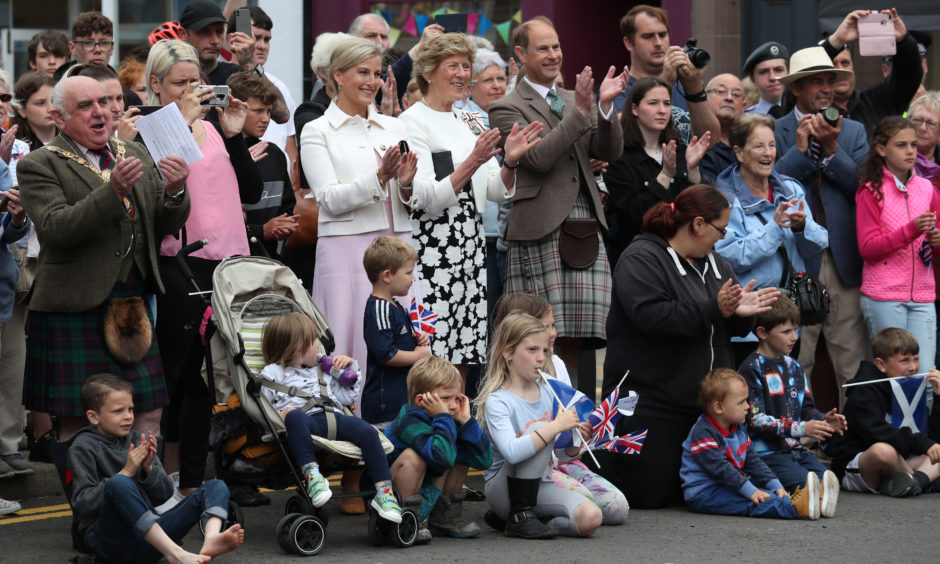 The Earl and Countess of Forfar applaud a highland dancing performance.