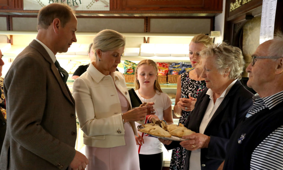 The Earl and Countess of Forfar try a Forfar Bridie whilst visiting Saddler's of Forfar Bakery in Forfar.