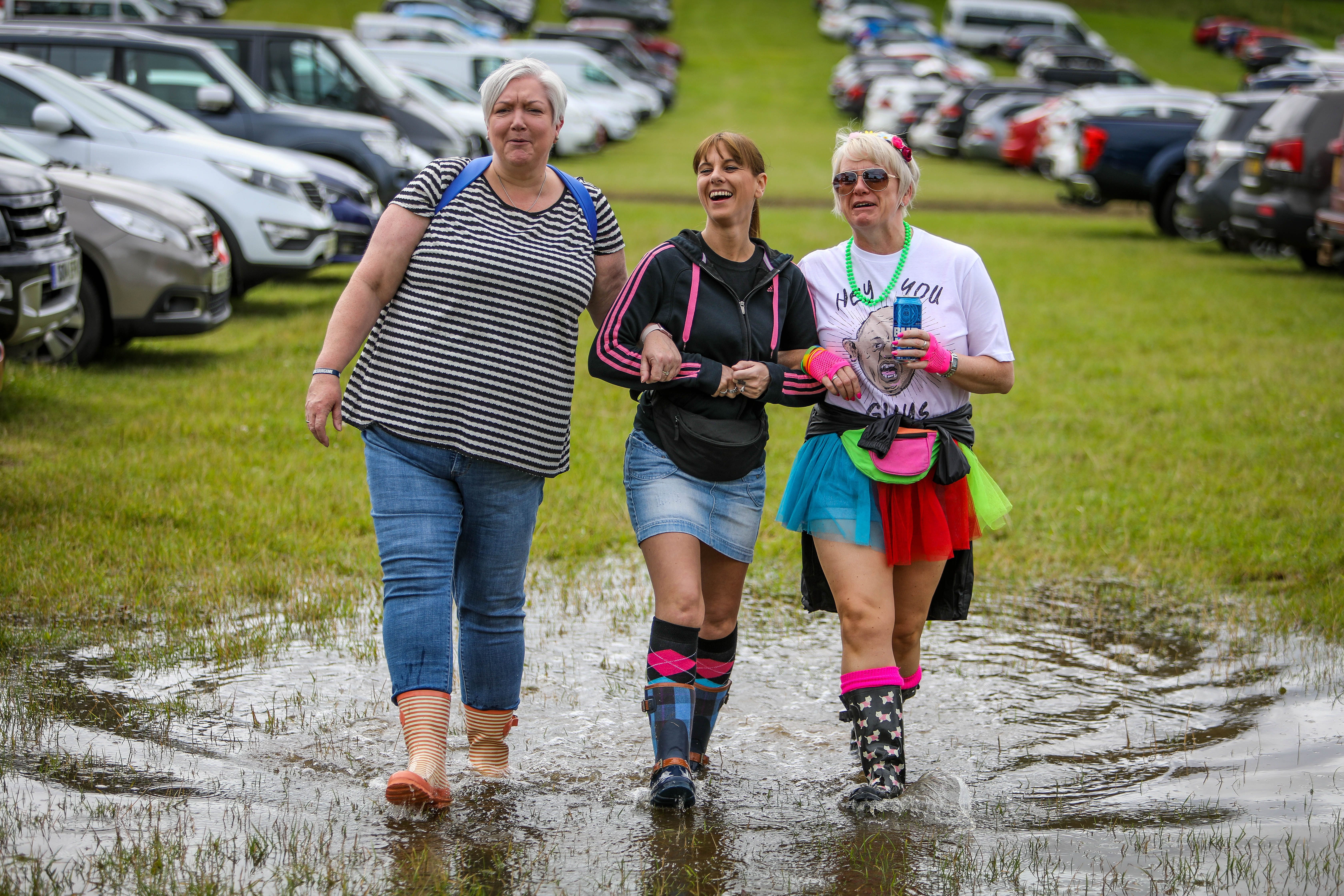 Gail Whyte (49), Leanne Williamson (39) and Elaine Lawrence (48) from Dundee, don't let a puddle stop them heading into Rewind.