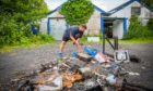 David Low looks through the damage and burned objects. Hartland Wrestling Club, Welton Road, Blairgowrie.