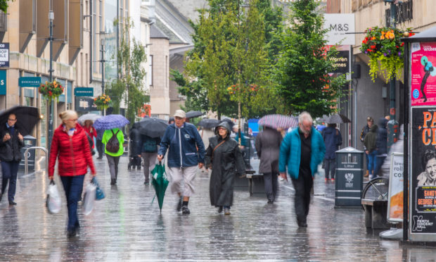 Shoppers on a wet Perth High Street.
