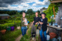 Picture shows, left to right, Judith McGowan, Sam Parry and Cristy Gilbert -  the three farmers that run the garden.