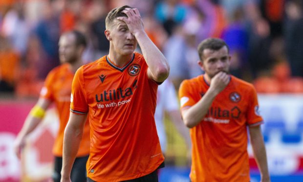 United pair Paul Watson, left, and Paul McMullan ponder the cup defeat..