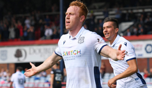 Danny Johnson, left, wheels away to celebrate his goal.