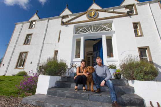 Carphin House owners Ruth and Ian Macallan with dog Hugo outside their home.