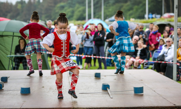 Highland Dancers take to the stage in front of the two judges.