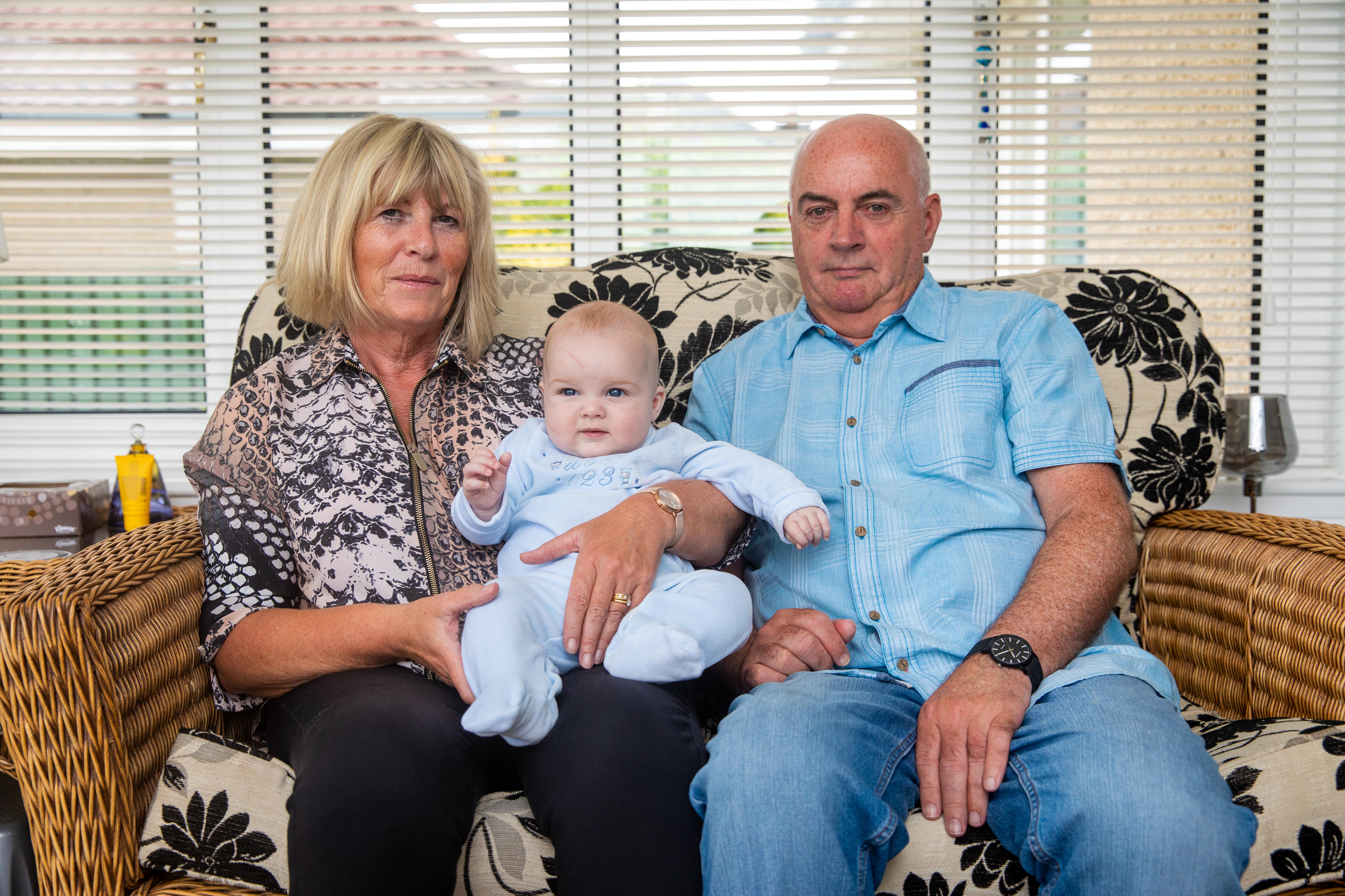 Anne Anderson (64), Baby Maximus Redfern-Anderson (5mth) and Stuart Anderson (64) from Tullibody at home after their stay