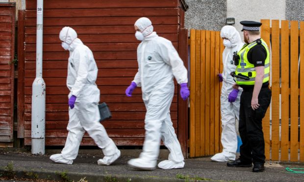 Forensic officers at the house in Glenrothes.