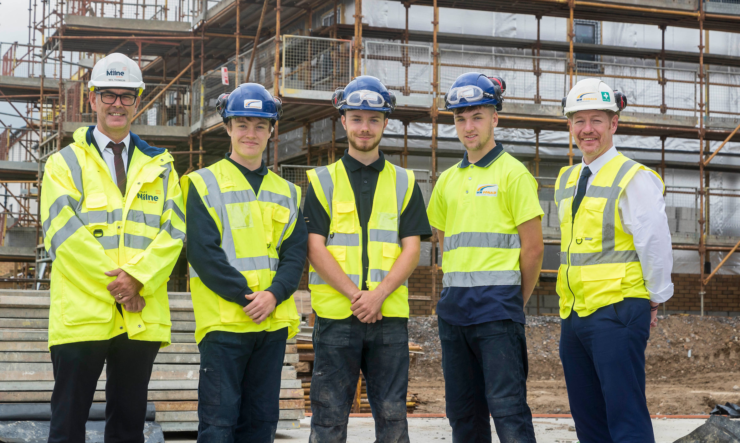 Stewart Milne Construction director Neil Thomson (left)  with workers from Stewart Milne Homes North