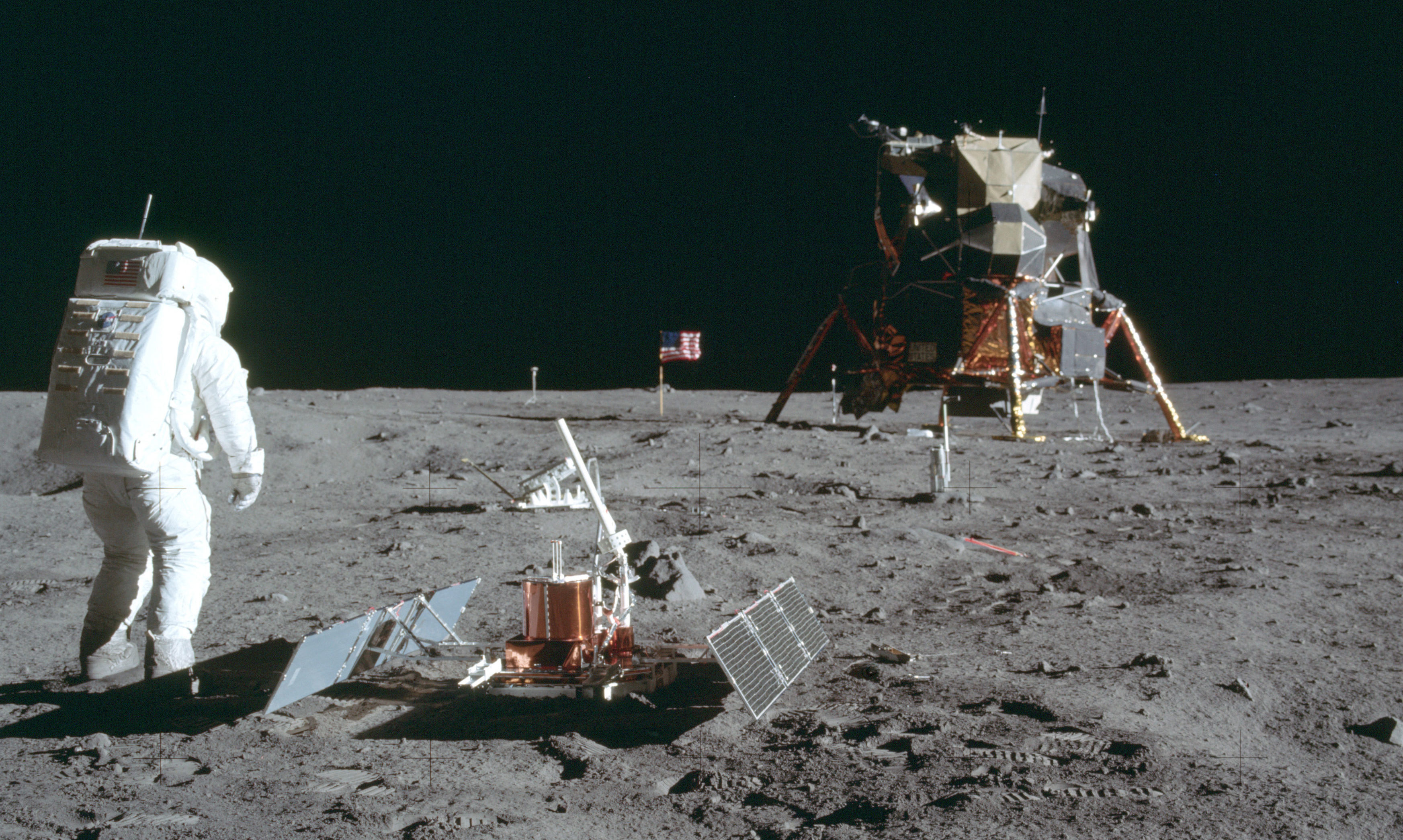In this July 20, 1969 photo made available by NASA, astronaut Buzz Aldrin Jr. stands next to the Passive Seismic Experiment device on the surface of the the moon during the Apollo 11 mission.