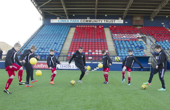 Development officer Adam McWilliam coaching  children at Links Park.