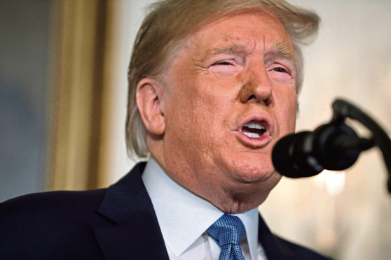 President Donald Trump speaks about the mass shootings in El Paso, Texas and Dayton, Ohio, in the Diplomatic Reception Room of the White House, Monday, Aug. 5, 2019, in Washington. (AP Photo/Evan Vucci)