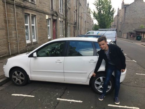 Andrew Cuthbert with his damaged car.