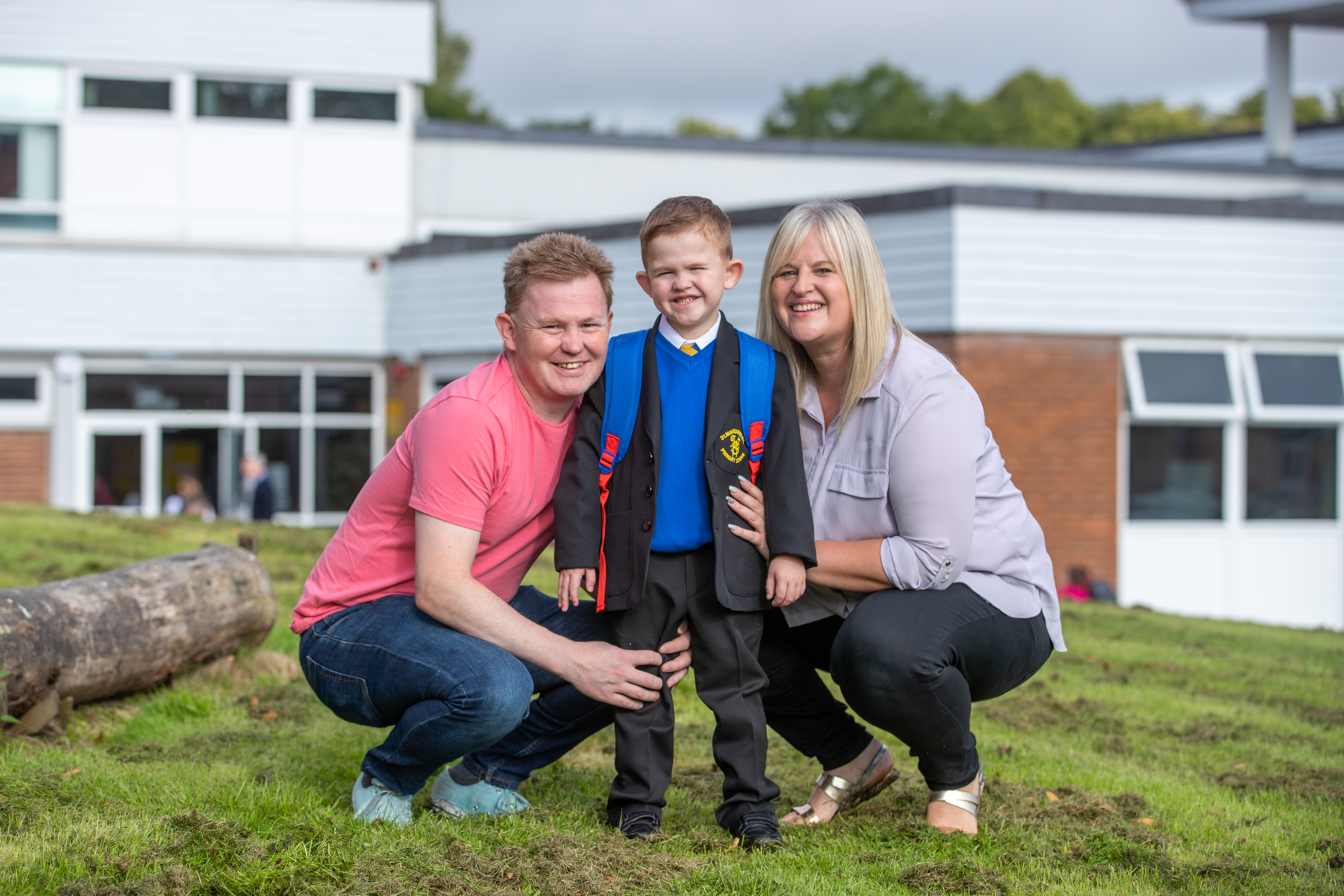 Daniel is pictured outside the school with mum Louise Paton and Dad Nicky Cornet.