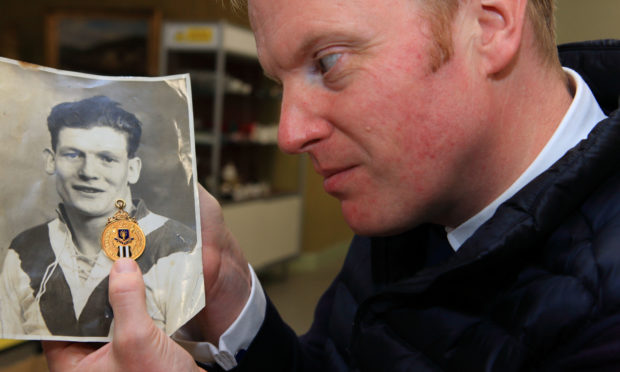 Nick Burns of Lindsay Burns Auctioneers with a rare League Winners/Forfarshire Cup winners medal awarded in 1928/29 to William "patsy" Deuchar.