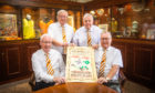 left to right is Ian Wightman, Peter McBride, Tom Cairns and Jim Laing (all Dundee United Business Club) with the poster promoting the event in 1909.