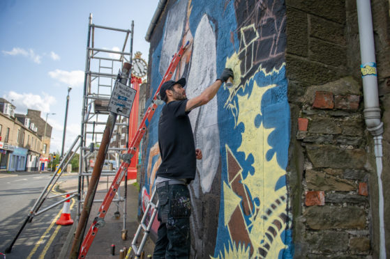 Sabien works on an Oor Wullie mural