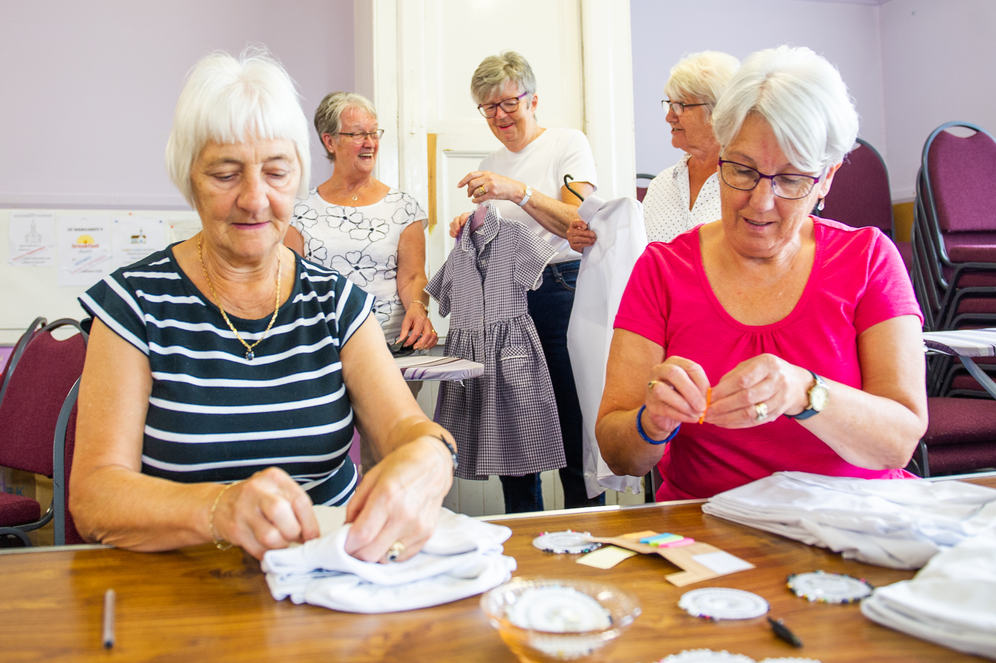 Dorothy Bruce and Ann Menmuir, front, mend uniforms ahead of the opening of Forfar's pop-up shop, aided by fellow volunteers Diane Robertson, Lynne Morrison and Muriel Drummond.