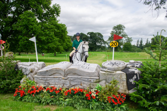 Louise Waugh and mount Robbie contemplate one of the  carved obstacles with a local theme at Glamis Castle.