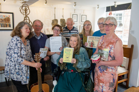 Some of the participants in the Orlang Project with the leaders (from left) musician Christine Kydd, Evan Duncan, Gail Robertson, Ian Ross, Pat McCafferty (seated front), artist Maureen Crosbie, Ginny Graham and Evelyn Bennett at Bank Street Gallery.