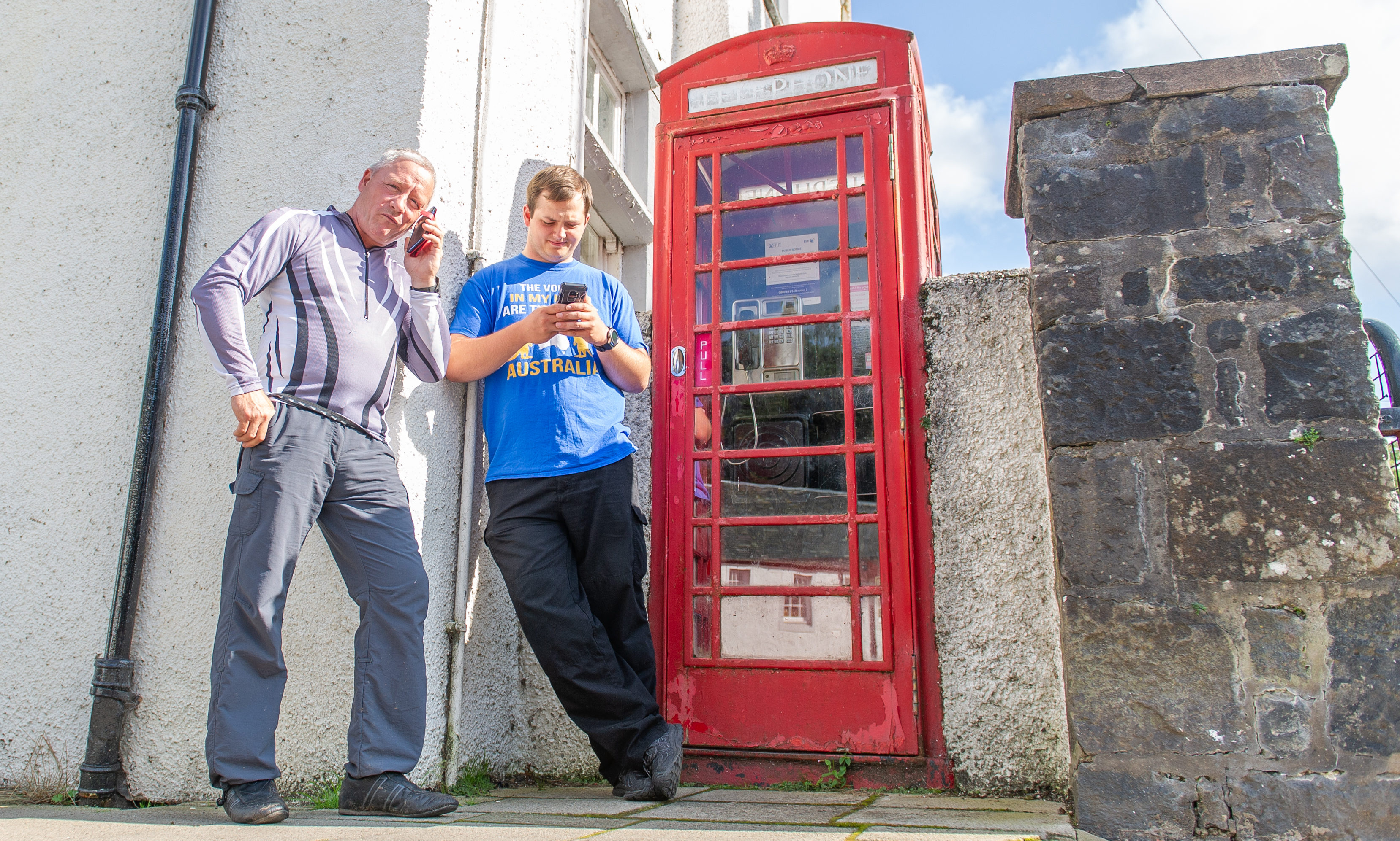 Courier News - Perth - Stefan Morkis story; CR0012898 Ross Gardiner. Picture Shows; l to r - Eddie Jackson and Steve Duffield who are in Dunkeld with the Cleveland ACF and the phone box at The Cross, Dunkeld, 13th August 2019. Pic by Kim Cessford / DCT Media