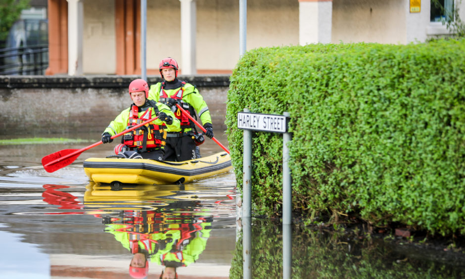Residents had to be evacuated from houses in the Park Road area of Rosyth after intense rain fall saw houses flooded. Pic shows; flooding in the area with Scottish Fire and Rescue rescuing residents, retrieving medication and pets with inflatable boats. Picture by Kris Miller / DCT Media