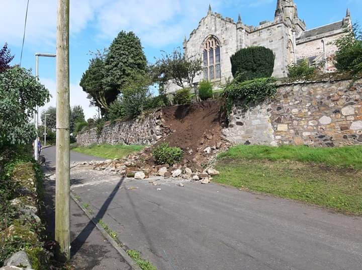 Graveyard wall collapsed after heavy rain.