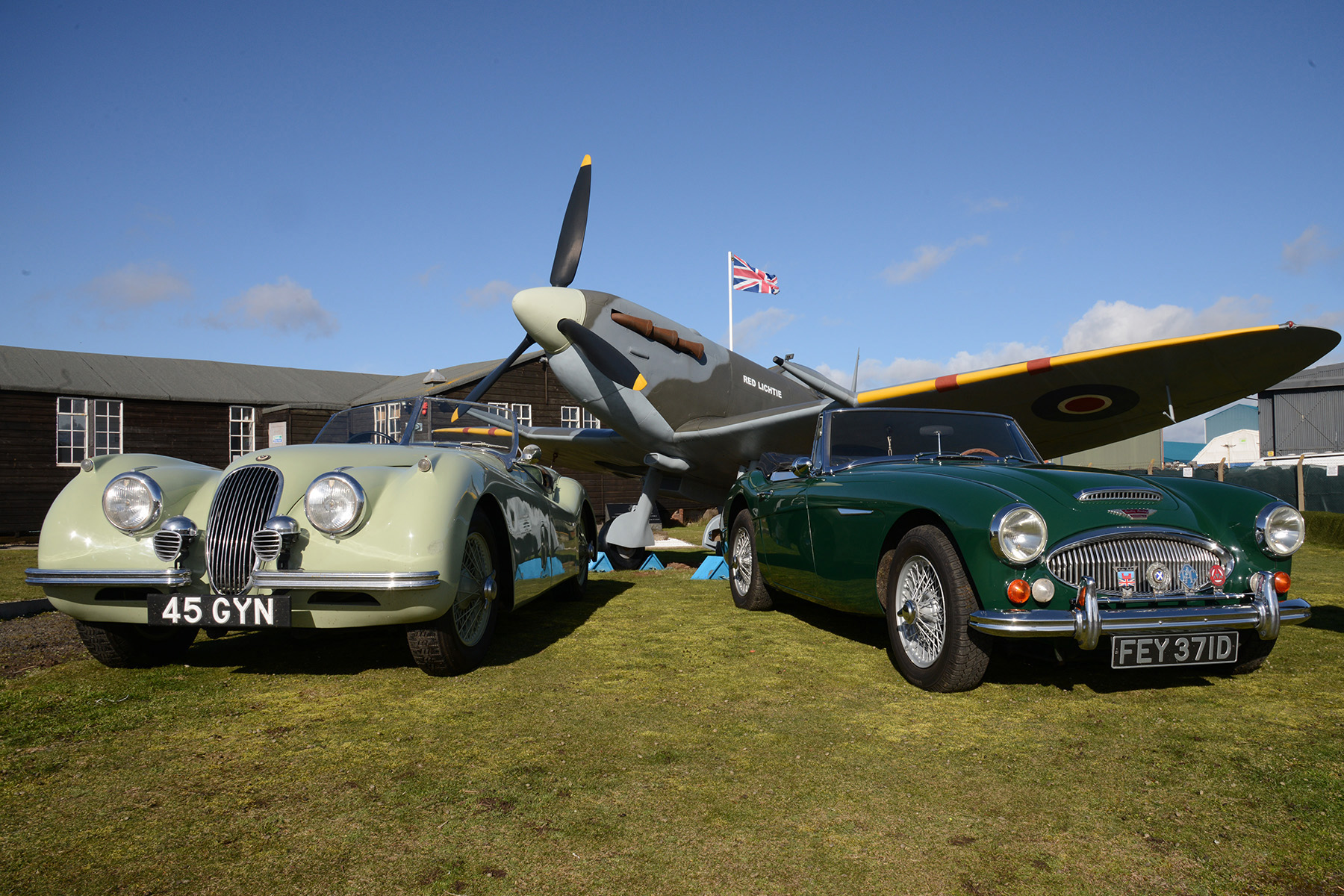 Richard Burton's Jaguar XK120 and an Austin Healey 3000 alongside the Red Lichtie replica Spitfire at Montrose in 2019