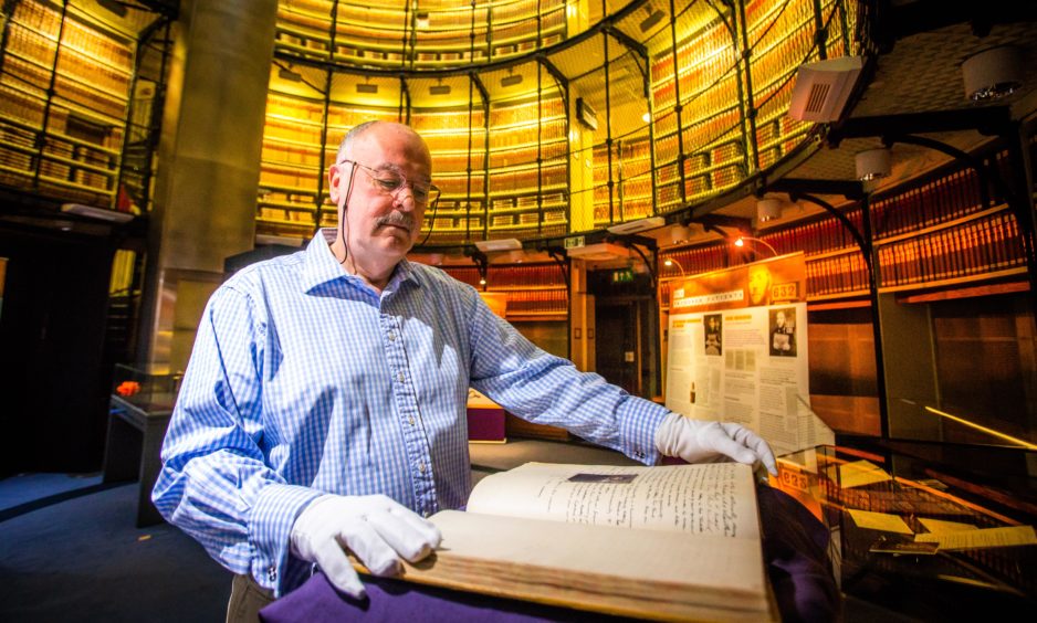 A new exhibition by National Records of Scotland (NRS) named "Prisoners or Patients? Criminal Insanity in Victorian Scotland" has opened, showcasing never before seen records revealing the hidden histories of prisoner-patients of the Victorian era. Picture shows guest curator Professor Rab Houston, University of St Andrews, with the rare prison register. 
Picture by Steve MacDougall / DCT Media