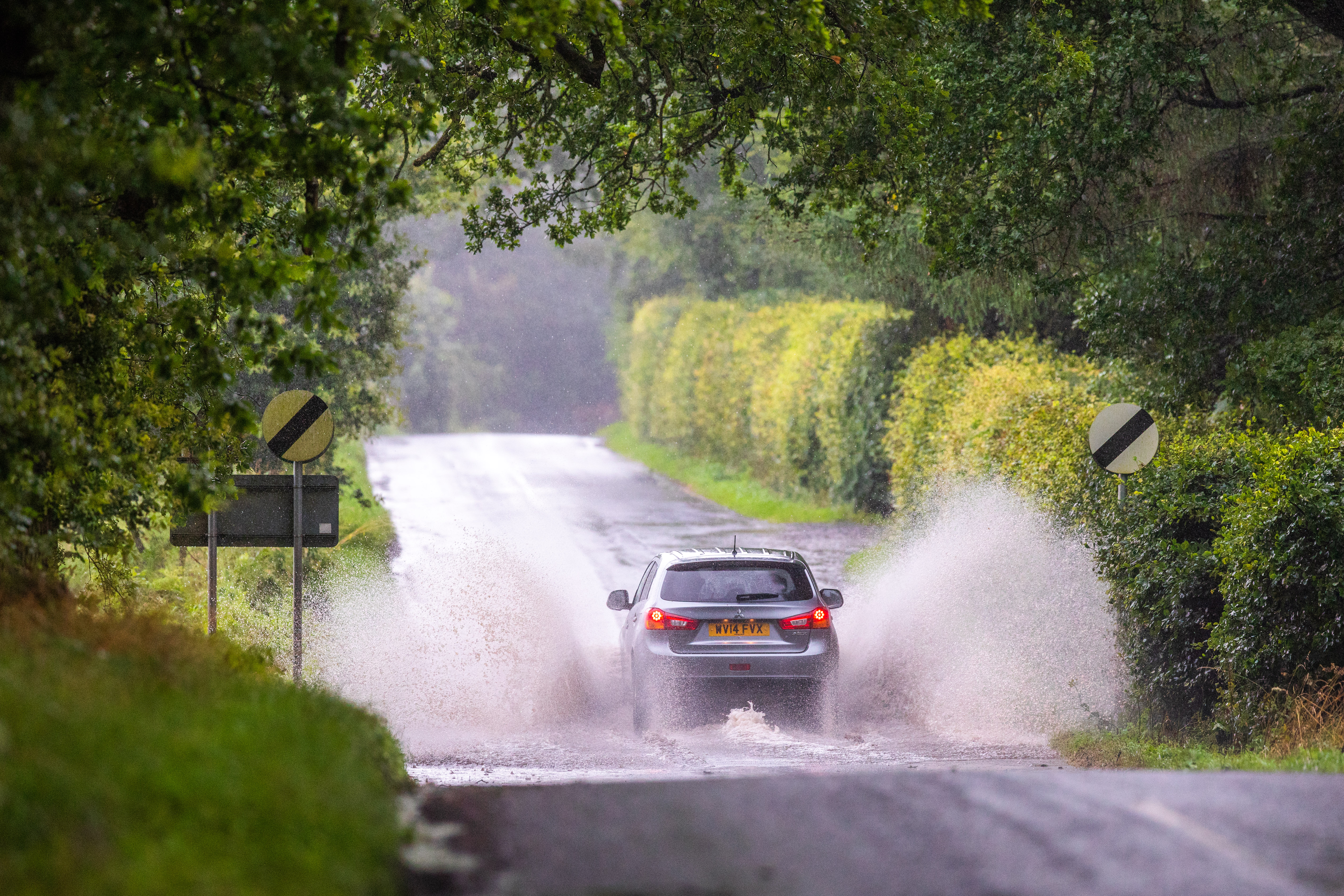Cars drive through surface water on Castleton Road, Tullibardine, by Auchterarder, earlier in August.