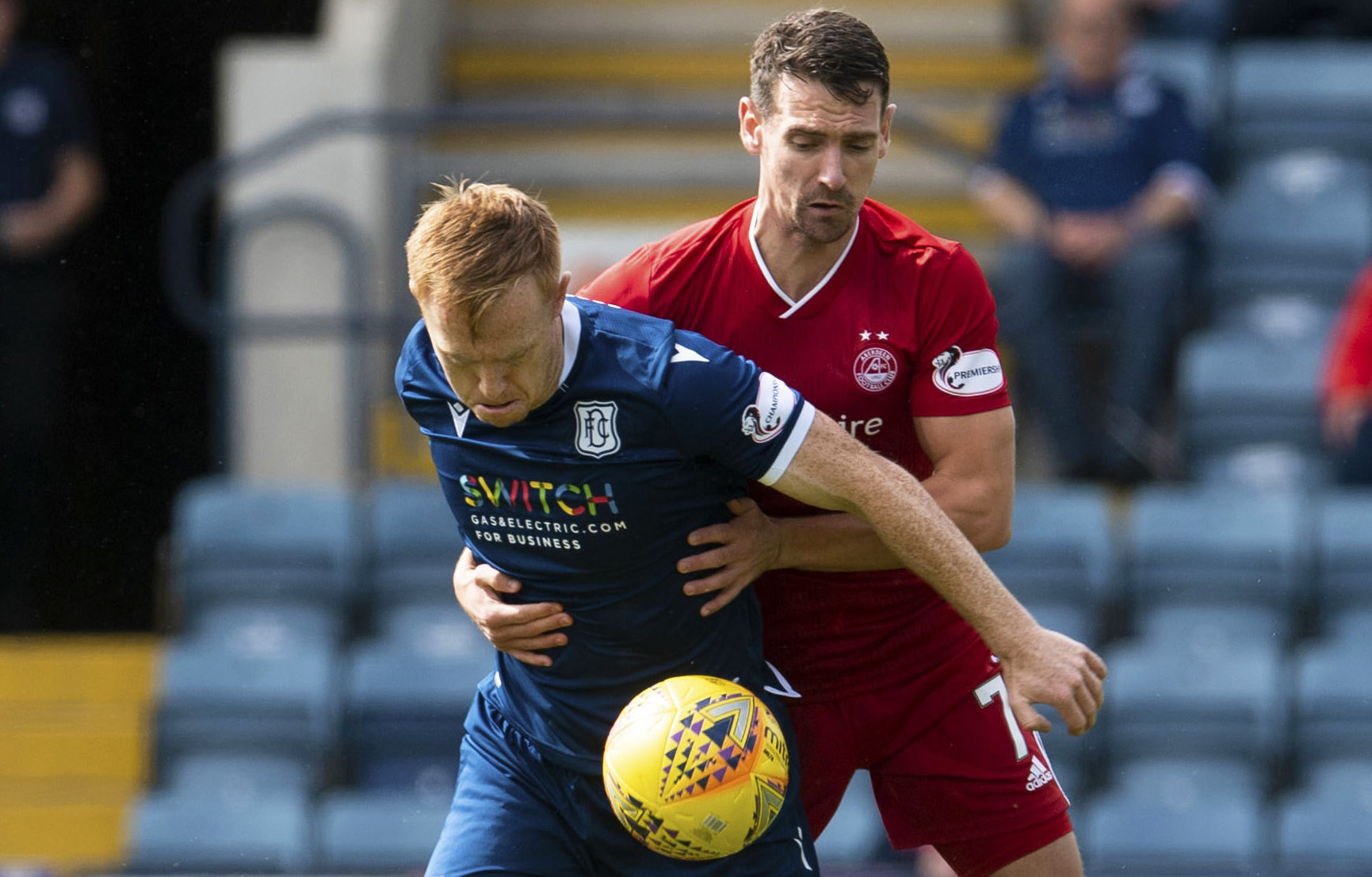 Dundee striker Danny Johnson battles with Aberdeen's Craig Bryson.