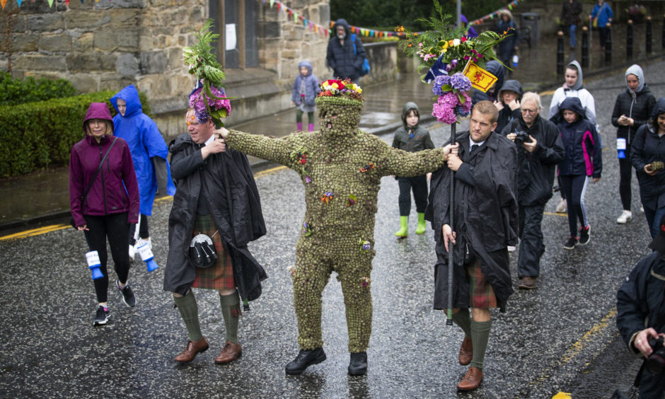 Burryman Andrew Taylor, accompanied by Andrew Findlater and Duncan Thompson , meets residents as he parades through the town of South Queensferry, near Edinburgh, encased in burrs. The parade takes place on the second Friday of August each year and although the exact meaning of this tradition has been lost through the years it is thought to have begun in the 17th Century. The tradition is believed to bring good luck to the towns people if they give him whisky offered through a straw or a donation of money.