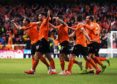 United's players celebrate Calum Butcher's opening goal.