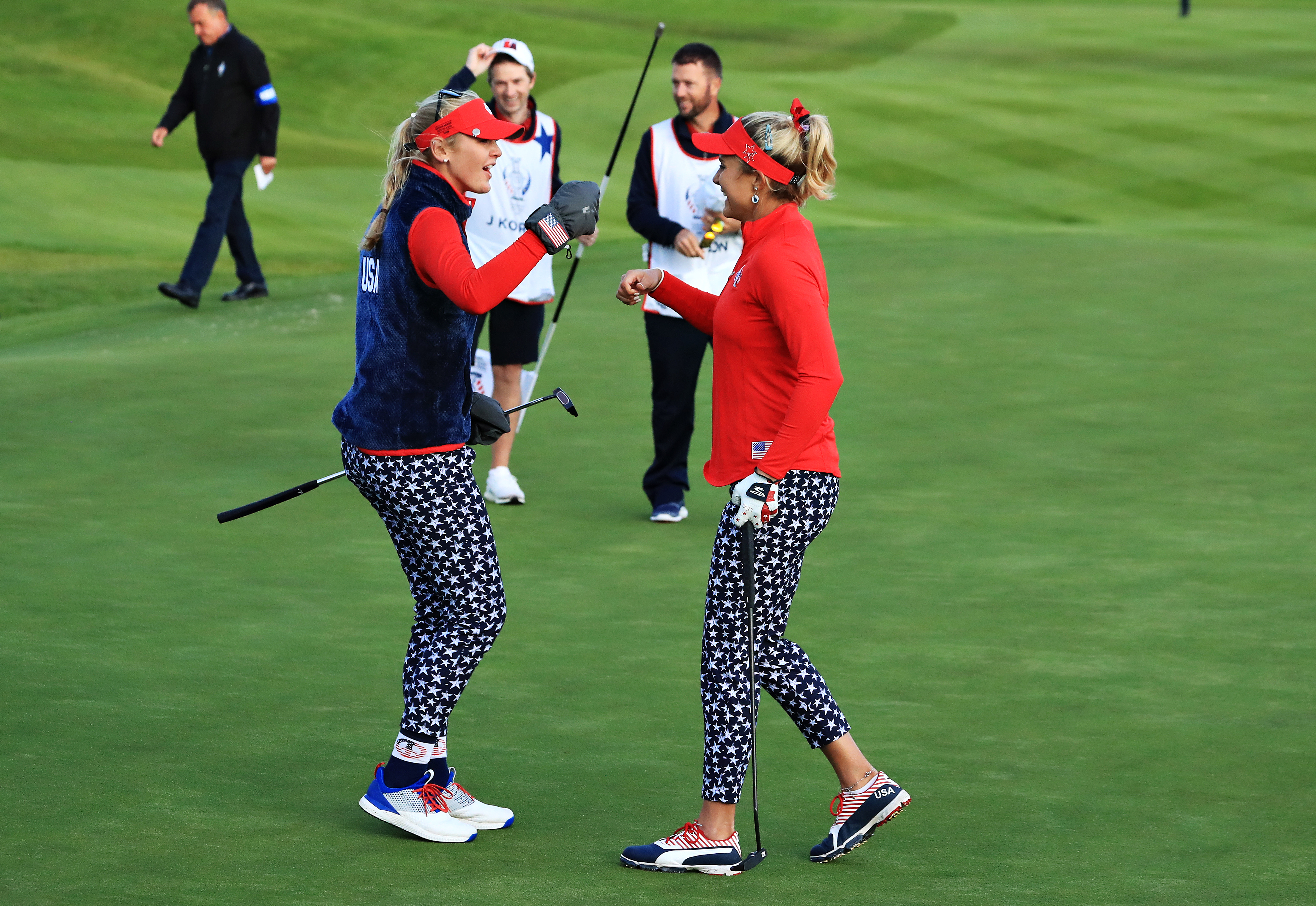 Lexi Thompson (l) and Jessica Korda of Team USA celebrate after securing a half to restrict Europe's lead on the first day of the Solheim Cup.