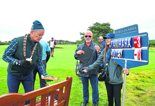 Bill Murray hands the scorer a hot dog during Day two of the Alfred Dunhill Links Championship at Carnoustie.