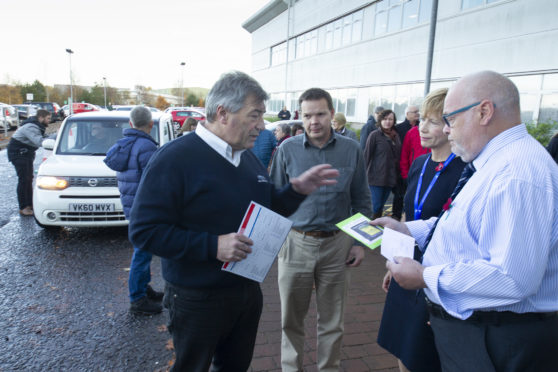 Parking protester Barrie Ewart handing over his petition against parking charges to administration leader  councillor David Fairweather.