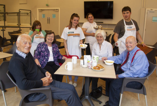 At Douglas Community Centre customer (seated L to R) Noel Patrick, Shirley Gibson Elizabeth Sinclair James Young  being served by staff (L to R) Edith Hawkins Lesley Ann Bruce Amanda Oudney. Gareth Hathway