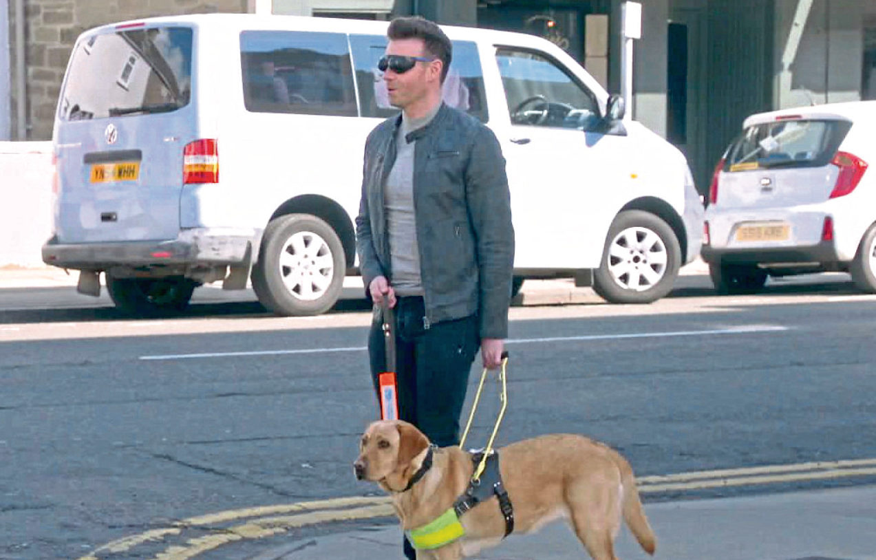 Des Clarke in Broughty Ferry with a guide dog.
