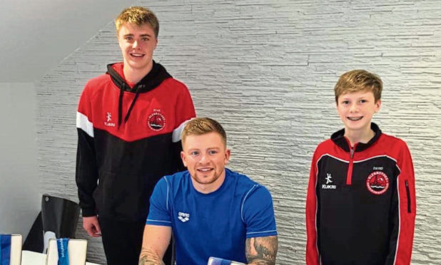Glenrothe ASC members Ryan King (left) and David Smyth  got to meet their hero Olympic and World Champion Adam Peaty at a swim clinic in Cumbria.