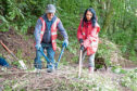 Ramsay Mudie of the Kirrie Den Project and Gayle Ritchie tidy up an embankment.
