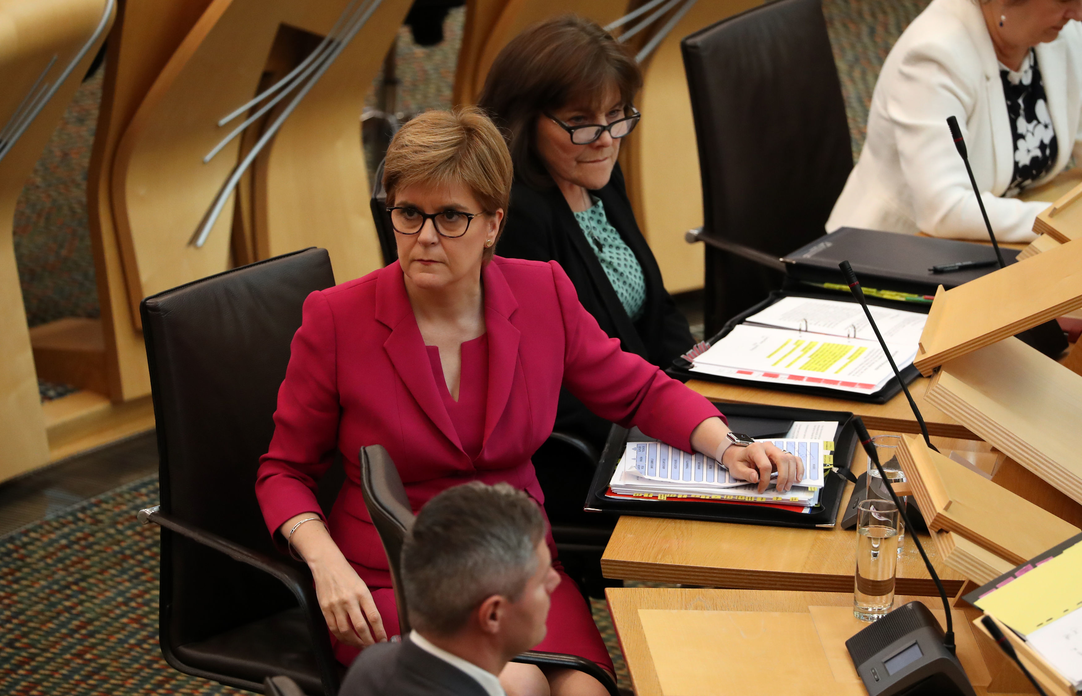 First Minister Nicola Sturgeon alongside Health Secretary Jeane Freeman in the debating chamber during First Minister's Questions at the Scottish Parliament in Edinburgh.