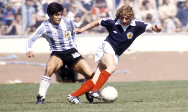 Argentina's Diego Maradona (left) with Asa Hartford at Hampden during an international fixture against Scotland.