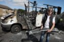 MyBUS director Mary Parry with the burnt out minibus.